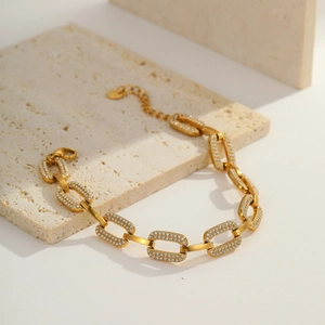 Detail of 18K gold plated chain bracelet with rectangle links and micro zircon pavé setting