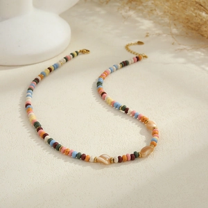 Close-up of bohemian colorful beads and starfish necklace with golden lobster clasp