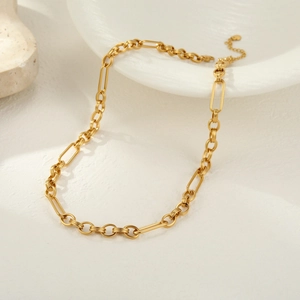Close-up of golden chunky chain necklace with irregular rectangle links and lobster clasp