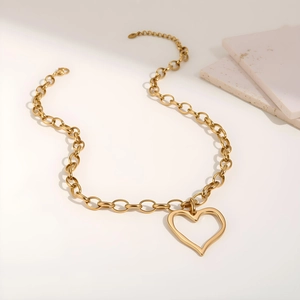 Detailed view of the gold chunky link chain necklace with hollow heart pendant and clasp