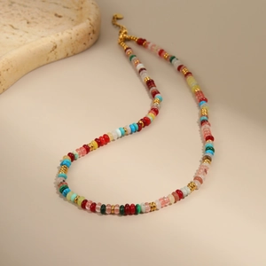 Detail of colorful bohemian beads necklace with gold lobster clasp and adjustable chain