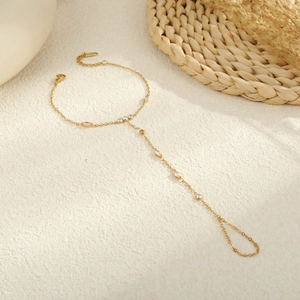 Elegant gold slave bracelet with sparkling marquise zircon stones and finger ring chain