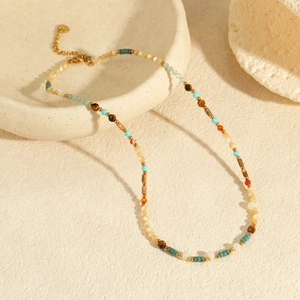 Detail view of Bohemian colorful bead necklace with turquoise, shell, and gold accents