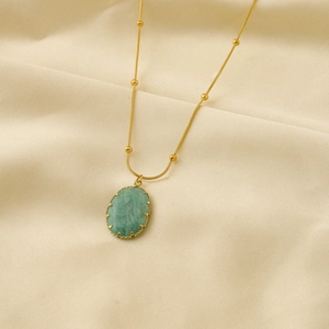 18K Gold Edelstahlkette mit ovalem grünem Natursteinanhänger auf Seidenhintergrund