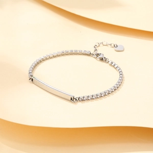 Pulsera tennis de acero inoxidable con placa para grabar y un pequeño colgante de corazón
