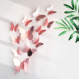 Macro detail of 3D rose gold mirror butterfly wall stickers with realistic wings