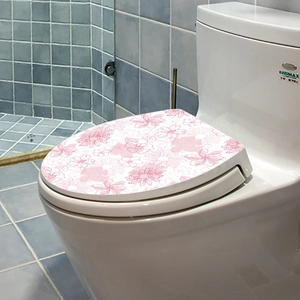 Detail of floral toilet lid sticker with pink flower pattern on blue tile background