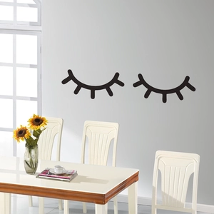 Creative black eyelash wall stickers in a modern minimalist dining room setting