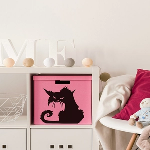 Pink fabric storage box with cartoon cat print in a cozy home shelving display