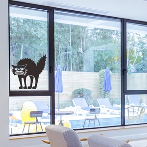 Creepy black cat window sticker decal for Halloween decor on a bright glass background