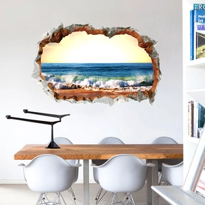 3D hole-in-the-wall sticker showing ocean waves and beach scenery in a modern room