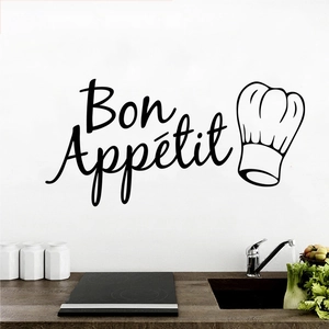 Detail of Bon Appétit vinyl wall sticker with chef hat icon on a white kitchen wall