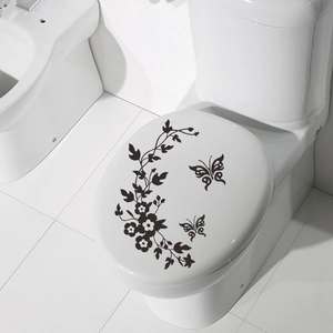 Elegant black butterfly and vine floral art sticker on a white bathroom toilet cover