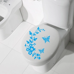 Blue butterfly floral vine decals applied on a clean white toilet lid for bathroom decor