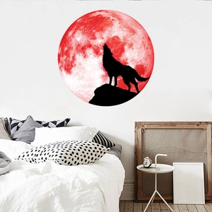 Glow-in-the-dark wall sticker featuring a howling wolf silhouette against a red moon