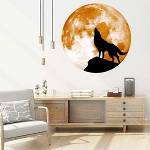 Detailed view of howling wolf silhouette wall sticker against a luminous moon in a living room