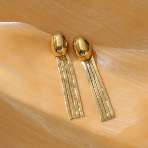 Macro detail of gold-plated irregular oval stud earrings with four snake chain tassels