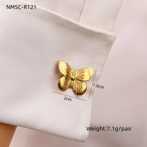 Golden butterfly cufflinks 2cm x 1.6cm on a shirt sleeve with detailed metal texture