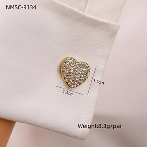 Macro detail of heart-shaped gold-plated cufflinks with rhinestones, 1.5cm x 1.5cm size