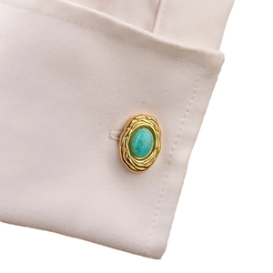 French shirt cufflinks in gold with turquoise stone and woven nest texture on sleeve