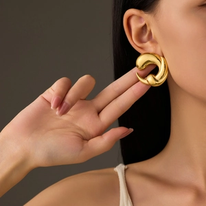 Chic gold-plated teardrop hoop earrings with high-polish finish on elegant model