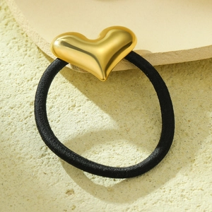Minimalist black elastic hair tie with a polished gold heart-shaped metal pendant