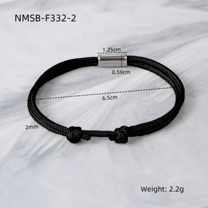 Detail view of handmade black braided rope bracelet with magnetic metal buckle and knot