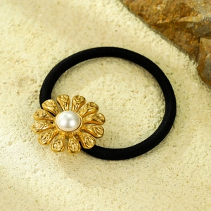 Vintage stainless steel sunflower hair tie with white pearl on a natural stone background