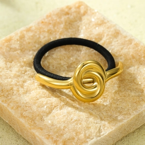 Detail of high-elastic black hair tie featuring a polished 18K gold-plated metal knot