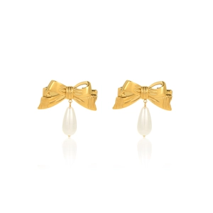 Detail of elegant gold bow hair clips with white teardrop pearl pendants on white background