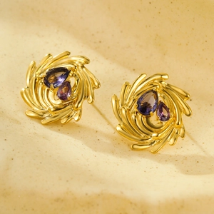 Vista detallada de pendientes de oro 18K con circonitas púrpuras en forma de gota