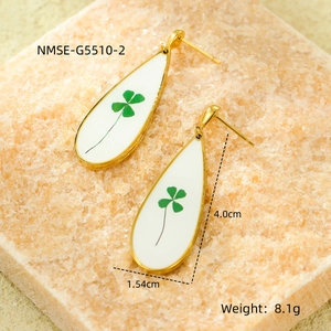 Detail view of teardrop earrings with green clover pattern and size measurements