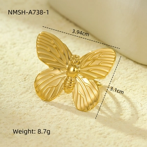 Detailed view of golden butterfly scarf buckle dimensions and weight on a beige surface