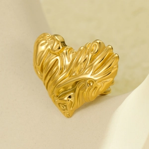 Minimalist gold heart ring with liquid metal texture and vintage luxury steel finish