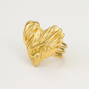 Macro detail of the golden heart ring featuring a molten liquid wave texture surface