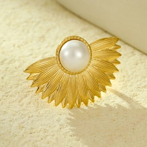Golden vintage pearl ring with sunburst metal base and elegant shell design