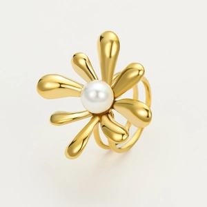 Detailed macro of a golden flower ring featuring a white pearl and triple band design