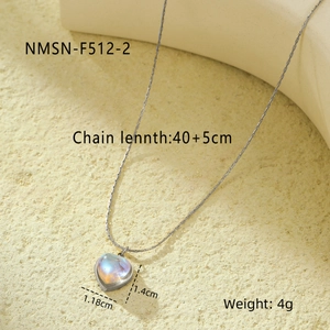 Detail of heart moonstone pendant necklace with dimensions 1.18x1.4cm on a textured surface