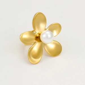 Detail of a gold stainless steel ring featuring a five-petal flower with a white pearl center