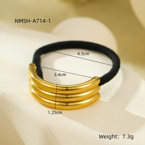 Macro detail of elastic hair tie with gold triple-layered metal ring showing size dimensions