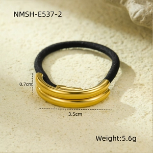 Macro shot of gold U-shaped metal accent on black elastic hair tie with 3.5cm width
