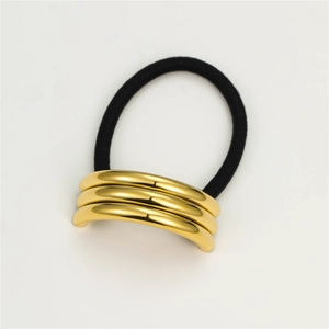 Detail of high-elastic black hair tie with triple-layered polished gold metal arc decoration