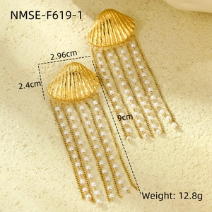 Detailed view of gold shell earrings with pearl tassels and specific size dimensions