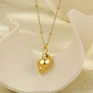 Elegant gold conch shell pendant necklace with bead accents on high-quality stainless steel