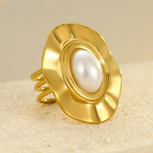 Luxurious gold stainless steel ring featuring a large white pearl on a wavy disk base