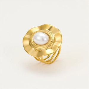 Detail of gold-plated wavy ring with oval white pearl and triple-layered band