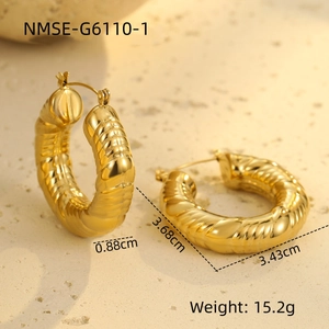 Detailed view of gold chunky hollow hoops with 3D spiral texture and dimensions