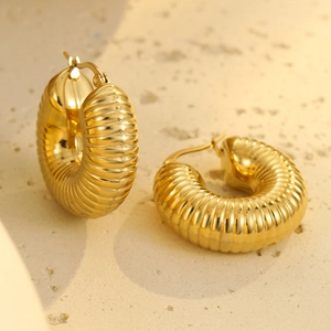 Detailed macro view of vintage gold hollow geometric texture hoop earrings for women