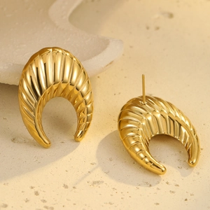 Detailed close-up of C-shaped 18K gold-plated earrings with vertical ribbed texture