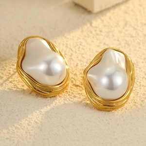 Vintage geometric gold stainless steel earrings with baroque pearls on sandy stone